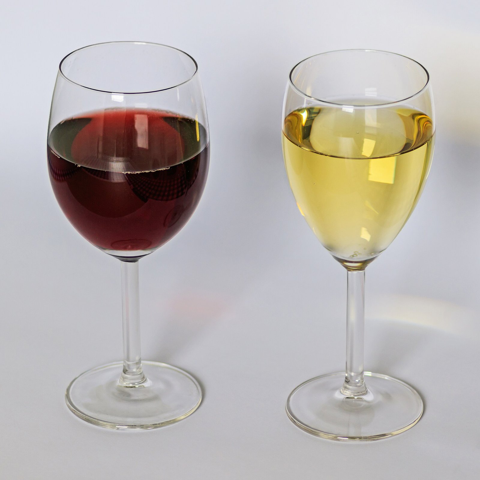 A glass of red wine beside a glass of white wine